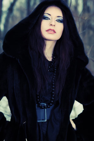 Shot of a gothic woman in a winter park. Fashion.の写真素材