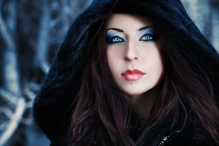 Shot of a gothic woman in a winter park. Fashion.