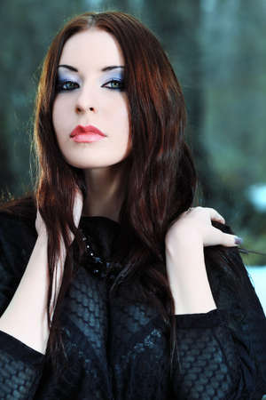 Shot of a gothic woman in a winter park. Fashion.の写真素材