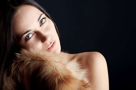 Portrait of a beautiful young woman in a fur.の写真素材