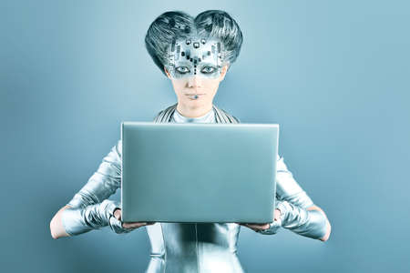 Shot of a futuristic young woman with a laptop. の写真素材