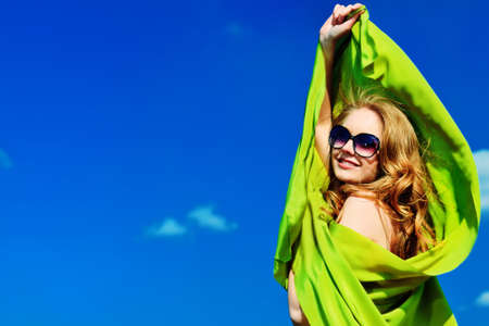 Beautiful young woman outdoors over blue sky.の写真素材