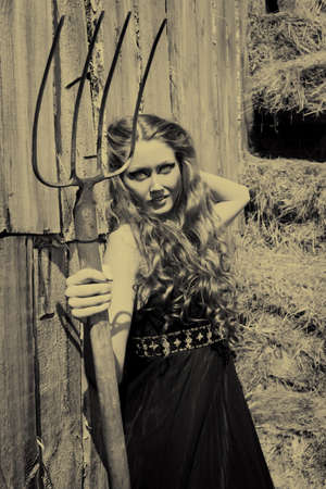 Charming woman witch at a countryside.の写真素材