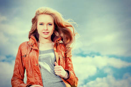 Beautiful young woman outdoors over blue sky.の写真素材