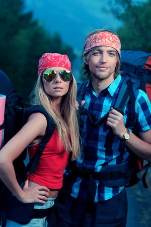 Couple of tourists making their journey at the mountains.の写真素材