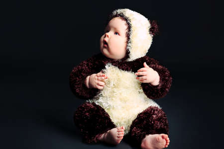 Beautiful baby in panda costume. Shot in a studio.の写真素材