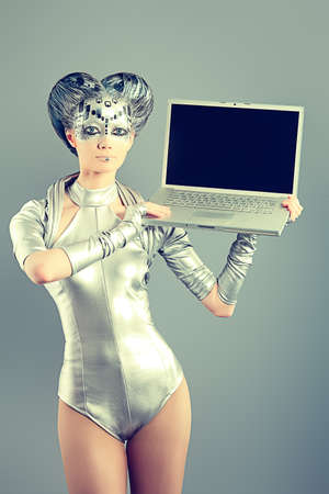 Shot of a futuristic young woman with a laptop. の写真素材