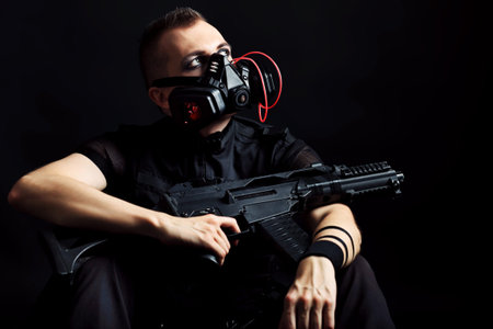 Shot of a conceptual man in a respirator holding a gun. の写真素材