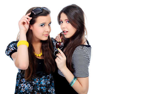 Two happy girls friends. Isolated over white background.の写真素材