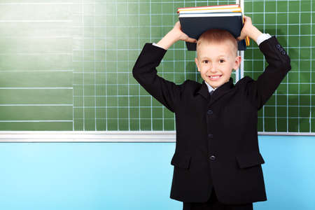 Portrait of a schoolboy in a classroom.の写真素材