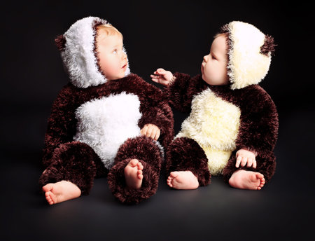 Beautiful babies in panda costume. Shot in a studio.の写真素材