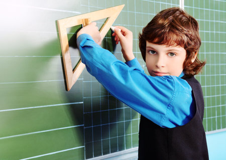 Portrait of a schoolboy in a classroom.の写真素材