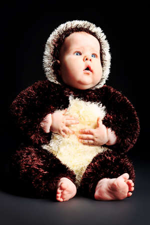 Beautiful baby in panda costume. Shot in a studio.の写真素材