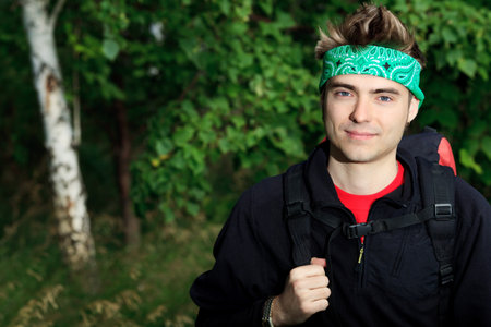 Portrait of a young man tourist posing outdoor.