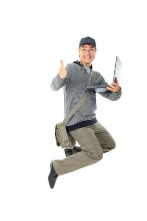 Shot of a happy jumping young man. Isolated over white background.の写真素材