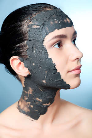 Portrait of a woman with spa mud mask on her face.の写真素材