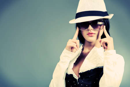 Fashion photo, a model is posing over grey backgroundの写真素材