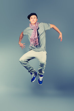 Young man dancing hip-hop at studio.
