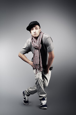 Young man dancing hip-hop at studio.
