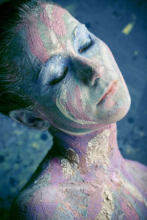 Portrait of an artistic woman painted in metal style. Shot in a studio.の写真素材