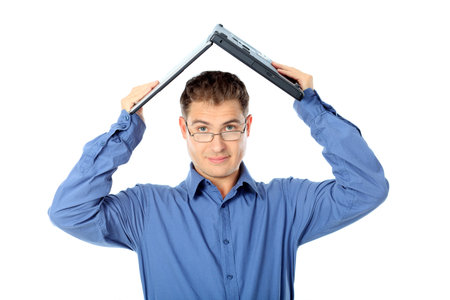 Portrait of a young handsome businessman with a laptop. Isolated over white background.