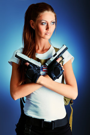 Shot of a sexy military woman posing with guns.