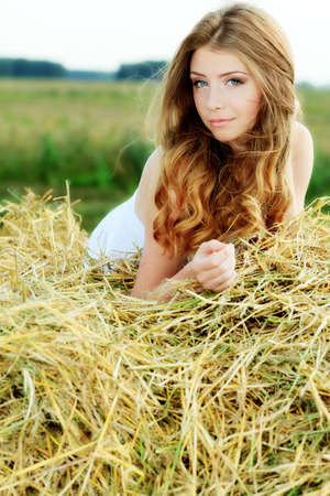 Romantic young woman posing outdoor.の写真素材