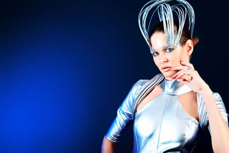 Fashion shot of a beautiful young woman over dark background.の写真素材