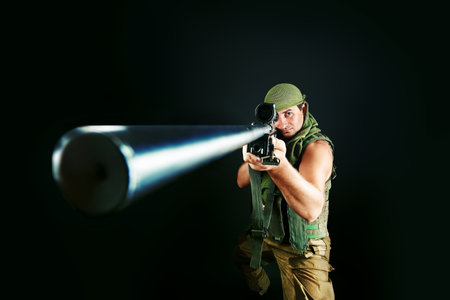 Shot of a conceptual soldier painted in khaki colors. Over black background.