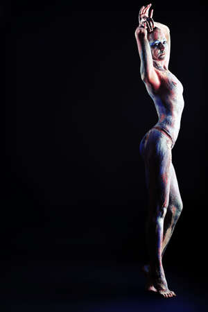 Portrait of an artistic woman painted with clay. Shot in a studio.の写真素材