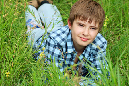 Portrait of a happy boy teenager outdoors.の写真素材