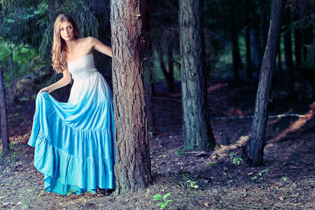 Romantic young woman posing outdoor.の写真素材