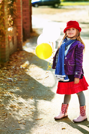 Shot of a cute girl walking at the park. Retro style. の写真素材