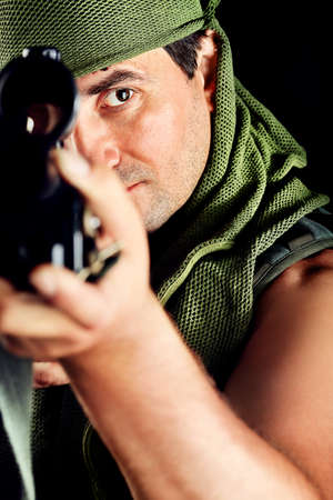 Shot of a conceptual soldier painted in khaki colors. Over black background.の写真素材