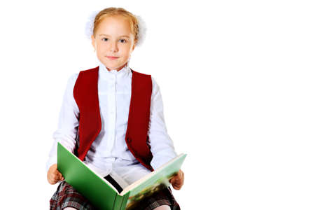 Portrait of a cute schoolgirl with a book. Isolated over white background.の写真素材
