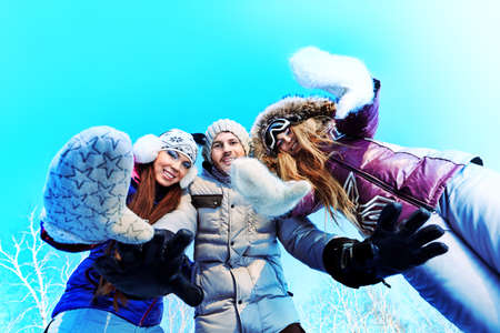 Group of young people having a rest outdoor in winter.の写真素材