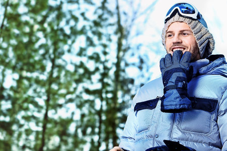 Shot of a young man with a snowboard outdoor.の写真素材