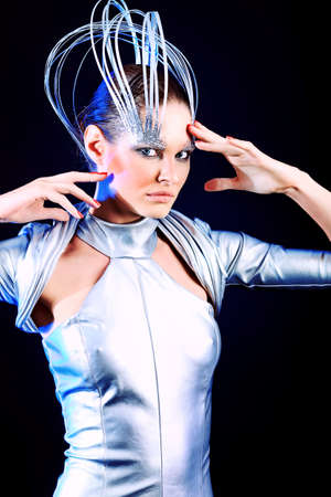 Fashion shot of a beautiful young woman over black background.の写真素材