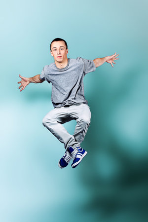 Young man dancing hip-hop at studio.