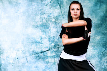 Modern teenage girl dancing hip-hop at studio.の写真素材