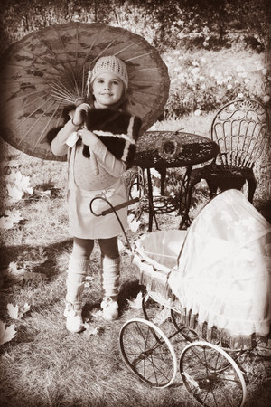 Shot of a cute girl walking with baby buggy at the park.