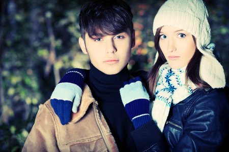 Portrait of a happy young couple in warm clothes outdoor.
