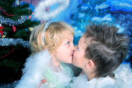 Beautiful little angels over Christmas background.の写真素材