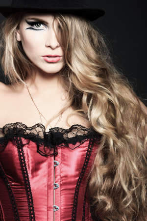 Portrait of a beautiful woman over black background.の写真素材