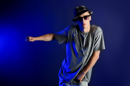Young man dancing hip-hop at studio.
