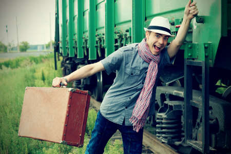 Portrait of a shouting young man holding a train.の写真素材