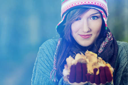 Beautiful young woman at the autumn park.の写真素材