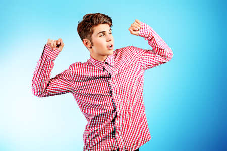 Stylish young man is dancing. Studio shot.の写真素材