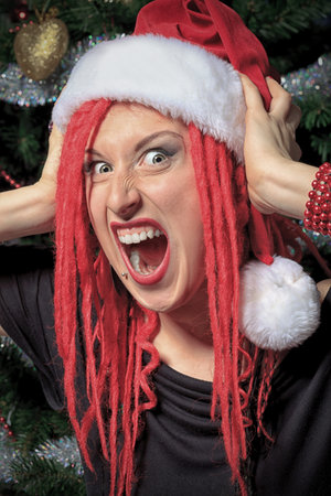 Funny young woman in Santa Claus costume is celebrating Christmas.