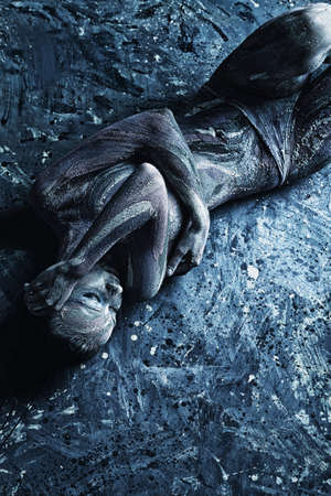 Portrait of an artistic woman painted with clay. Shot in a studio. の写真素材